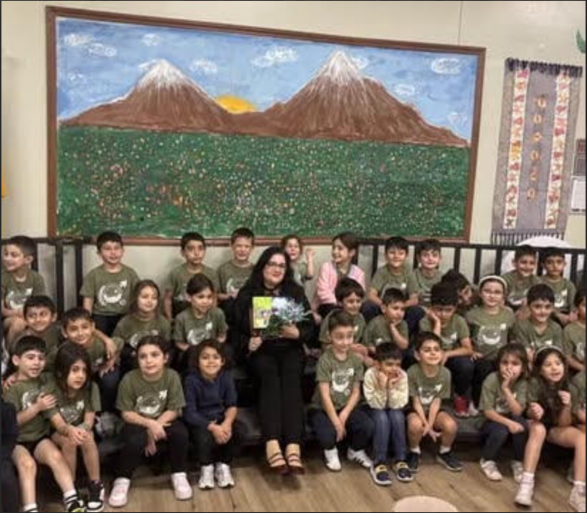 Aline with schoolchildren by a Mount Ararat mural