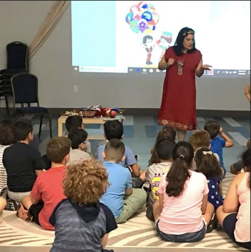 Aline presenting to children at a reading